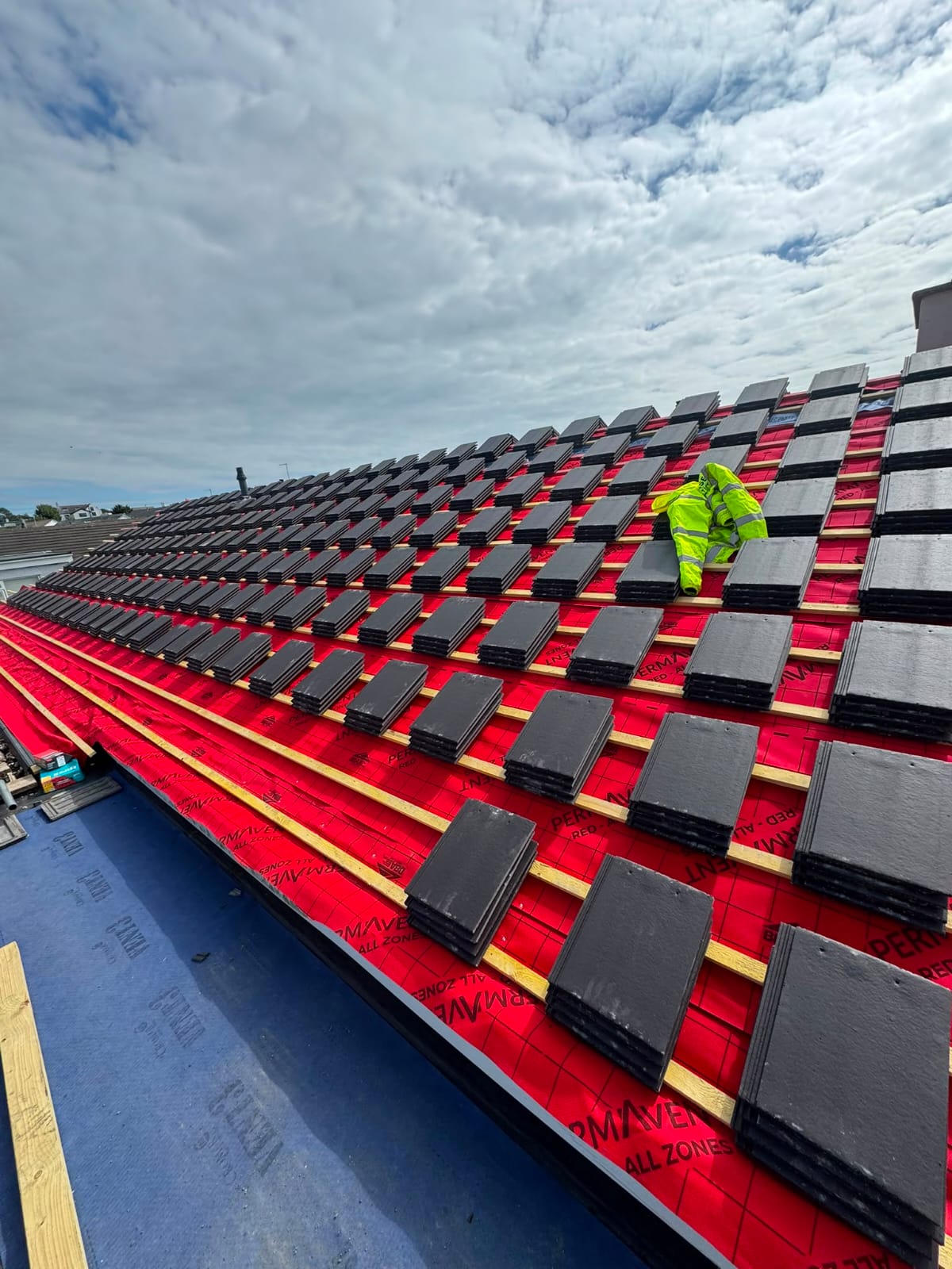 Roof rebuild in progress with new battens, breather membrane and roof tiles