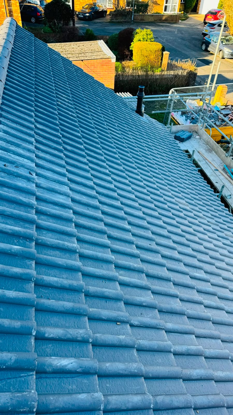 Re-tiled residential roof finished in blue-grey concrete roof tiles
