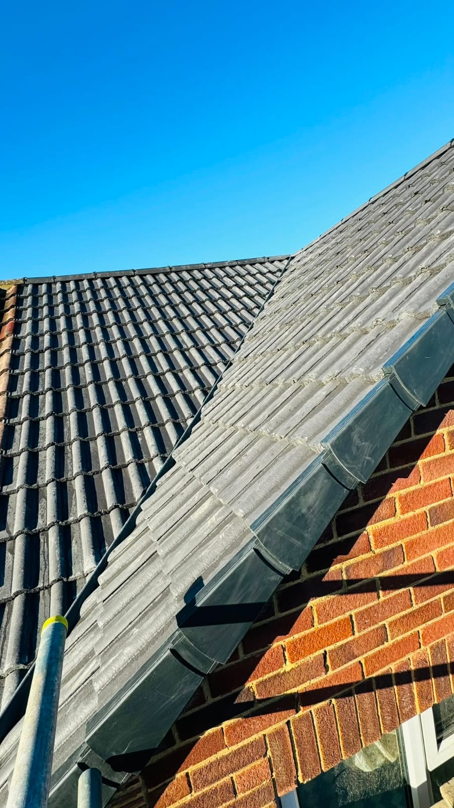 Lead flashing dressed where a tiled roof meets a brick wall